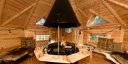 Wooden BBQ House with Central Firepit and Seating at The Fitz in Cockermouth, Lake District