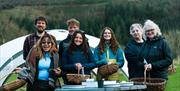 Visitors posing with Foraged materials with Forage Box