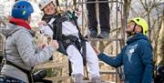 Visitors smiling while ziplining with Lake District Calvert Trust