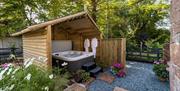 Hot tub and garden at Dandelion Cottage at Dandelion & Hoglet Cottages, near Dalston, Cumbria