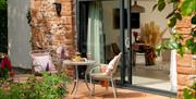 Outdoor seating at Dandelion Cottage at Dandelion & Hoglet Cottages, near Dalston, Cumbria