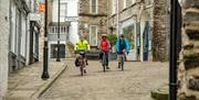 Visitors Cycling in Kendal with E-Bike Safaris Ltd in the Lake District, Cumbria