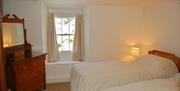 Twin bedroom with solid wood dressing table in No. 3 Main Street Cottage in Elterwater, Lake District