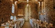 Interior of Eden Barn, set for a wedding breakfast in Kirkby Stephen, Cumbria