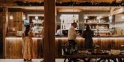 Guests at the bar at Eden Barn in Kirkby Stephen, Cumbria