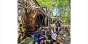Children playing outside Eskdale Mill in Boot, Lake District