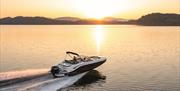 Boat on a Lake at Sunset, from Freedom Boat Club Windermere in Bowness-on-Windermere, Lake District