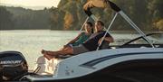 Family Enjoying the View from a Boat from Freedom Boat Club Windermere in Bowness-on-Windermere, Lake District