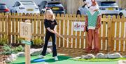 Child Playing at Foxy's Adventure Golf in Penrith, Cumbria