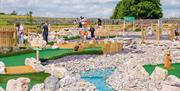 Family Playing at Foxy's Adventure Golf in Penrith, Cumbria