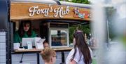 Visitors at Foxy's Hub food stall at Foxy's Adventure Golf in Penrith, Cumbria