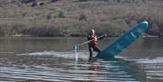 Visitors Paddleboarding with Genuine Adventures in the Lake District, Cumbria