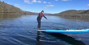 Visitors Paddleboarding with Genuine Adventures in the Lake District, Cumbria