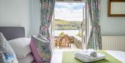 Bedroom with a Balcony in a Self Catered Cottage at the Graythwaite Estate in Graythwaite, Lake District