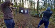 Visitors Shooting at Archery Targets with Green Man Survival in Newby Bridge, Lake District