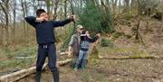 Visitors learning archery at the Two Day Wilderness Escape with Green Man Survival