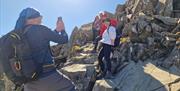 Visitors Taking Photos on Helvellyn via Striding & Swirral Edge with Guided Outdoors in the Lake District, Cumbria