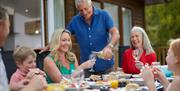Family Enjoying a Meal at a Gatebeck Holiday Park Holiday Home in Gatebeck, Cumbria