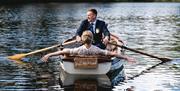 Bridal Couple on a Rowboat at a Wedding at The Gilpin Hotel & Lake House in Windermere, Lake District