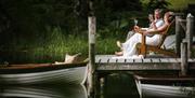 Bridal Couple posing on a Pier at a Wedding at The Gilpin Hotel & Lake House in Windermere, Lake District