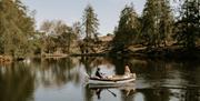Bridal Couple on a Rowboat at a Wedding at The Gilpin Hotel & Lake House in Windermere, Lake District