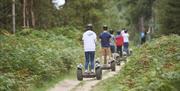 Visitors on Segways at Go Ape in Whinlatter Forest Park in Braithwaite, Lake District