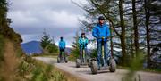 Visitors on Segways at Go Ape in Whinlatter Forest Park in Braithwaite, Lake District