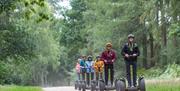 Visitors on Segways at Go Ape in Whinlatter Forest Park in Braithwaite, Lake District