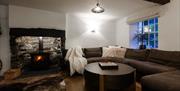 Living space with wood burner at Grange Bridge Cottage in Borrowdale, Lake District