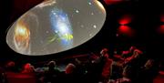 Visitors watching a display at the Grizedale Observatory in the Lake District, Cumbria
