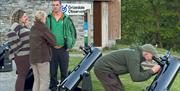 Visitors using telescopes at Grizedale Observatory in the Lake District, Cumbria