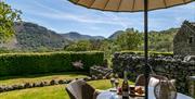 Patio seating and garden with Lake District views at Stone Cottage in Patterdale, Lake District