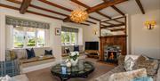 Living room with wood fire at Stone Cottage in Patterdale, Lake District