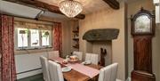 Dining room with grandfather clock at Stone Cottage in Patterdale, Lake District