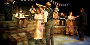 Actors performing on stage at The Victoria Wood Theatre in Bowness-on-Windermere, Lake District