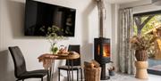 Dining table and wood burner in Hoglet Cottage at Dandelion & Hoglet Cottages, near Dalston, Cumbria
