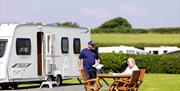 Couple at touring pitch at Holgates Holiday Park in Silverdale, Cumbria