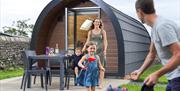 Family at a glamping pod at Holgates Holiday Park in Silverdale, Cumbria