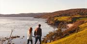 Couple for a walk along the coast in autumn near Holgates Holiday Park in Silverdale, Cumbria
