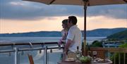 Couple enjoying a sunset at Holgates Holiday Park in Silverdale, Cumbria