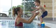 Mother and child playing in the pool at Holgates Holiday Park in Silverdale, Cumbria