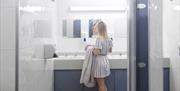 Woman in the Shower Facilities at Hollins Farm Holiday Park in Far Arnside, Cumbria