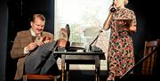 Actors performing on stage at The Victoria Wood Theatre in Bowness-on-Windermere, Lake District