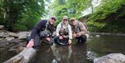Visitor posing with fish caught on a fishing trip with West Pennine Angling Solutions in the Lake District, Cumbria