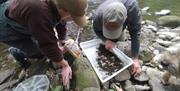 Visitors inspecting the conditions on a fishing trip with West Pennine Angling Solutions in the Lake District, Cumbria