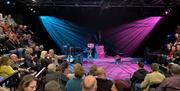 Visitors gathering in seating at The Victoria Wood Theatre in Bowness-on-Windermere, Lake District