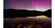 Aurora over a lake by Jonny Gios Photography