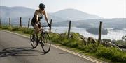 Visitor cycling at Keswick Mountain Festival in the Lake District, Cumbria