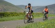 Visitors cycling at Keswick Mountain Festival in the Lake District, Cumbria