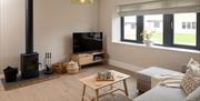 Living Room with Wood Burner at Rose Cottage by Lakes For All in Penrith, Cumbria